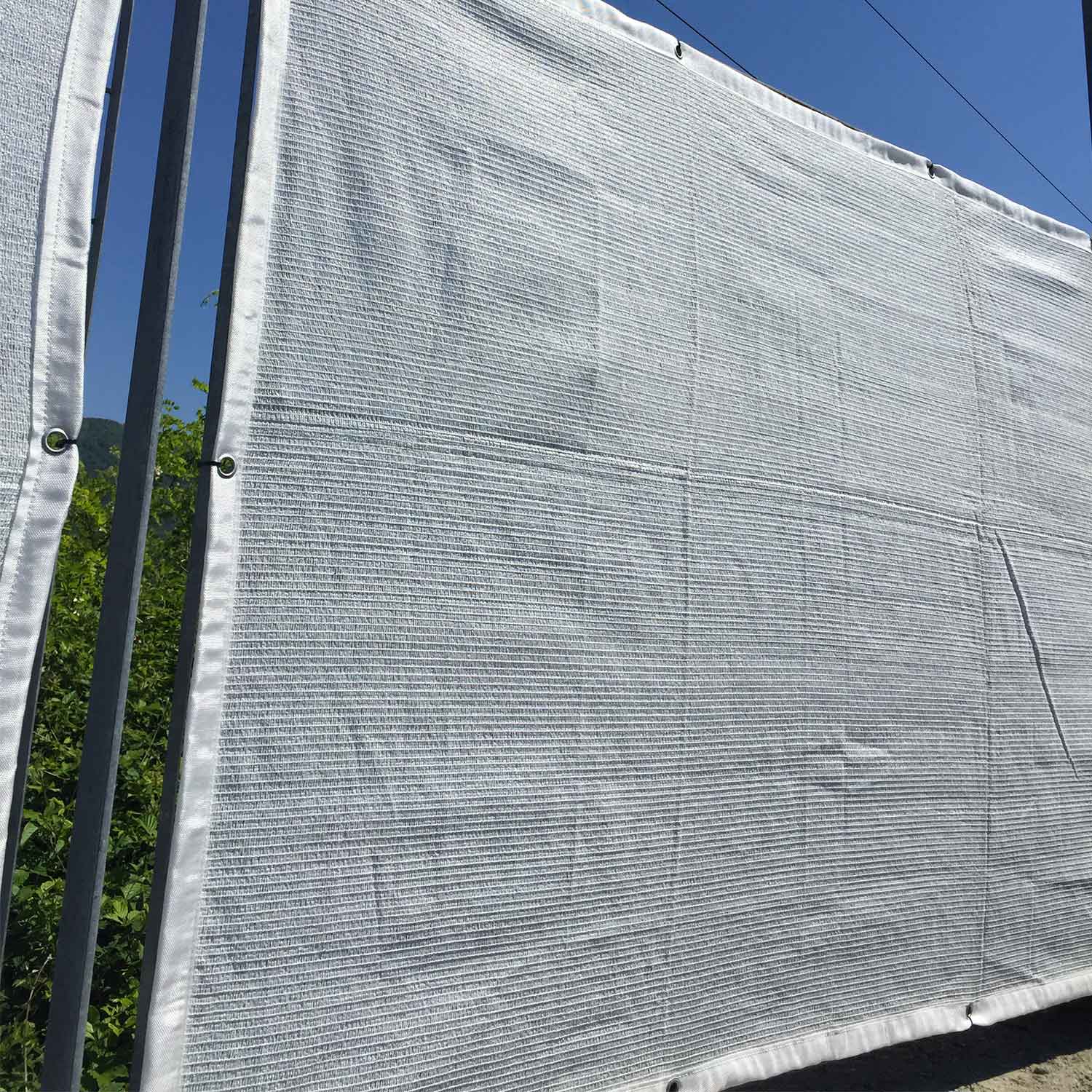 Nets and sheets for covering parking lots